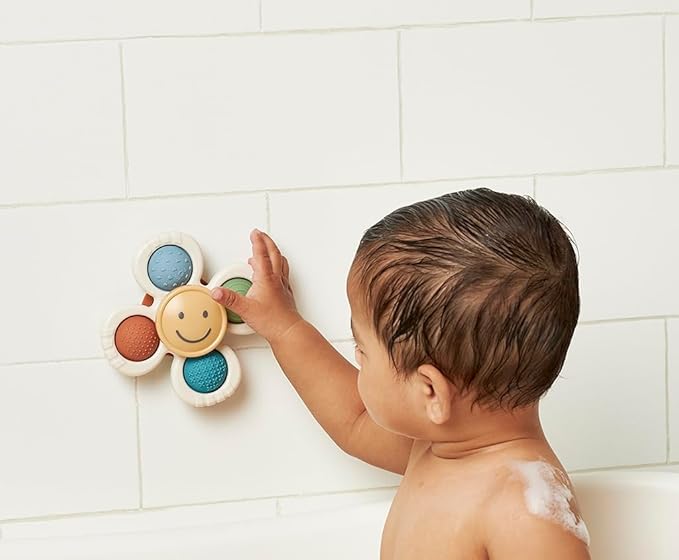 Itzy Ritzy Pop & Whirl – Fidget Spinner Travel & Bath Toy for Babies & Toddlers – Fidget w/Textured Silicone Poppers to Develop Fine Motor Skills – Sticks to Highchairs, Tables, Tubs More (Smile)