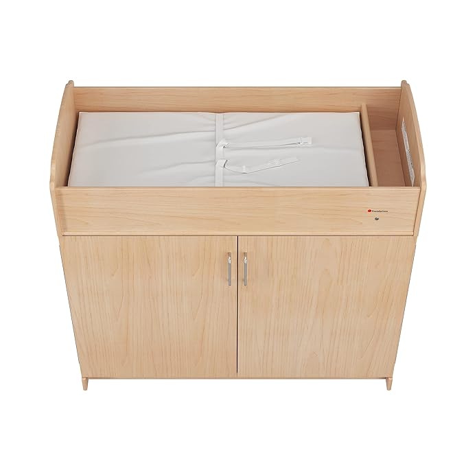 Foundations Serenity Daycare Changing Table with Storage Cubbies, Durable Wood Construction, Built-in Shelving for Ample Storage, Adjustable Safety Strap, Includes 1” Foam Mattress Pad (Natural)