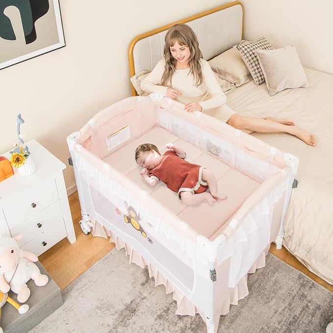 HONEY JOY 4-in-1 Pack and Play with Canopy, Portable Baby Playard w/Changing Table and Infant Bassinet Cute Toys & Music, Foldable Bassinet for Newborn and Toddler(Light Pink)