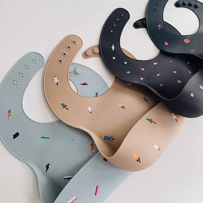 mushie Silicone Baby Bib | Adjustable Fit Waterproof Bibs (Rocket Ship)
